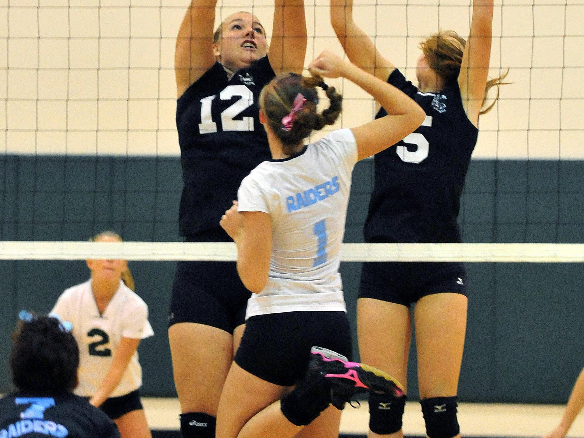 Rockledge highs #1 Alex Hollabaugh hits a shot over Mel Highs #12 Shelby Alsdorf and teammate #5Hannah Wilkins during Wednesday night match held at Melbourne High gym. CRAIG RUBADOUX FLORIDA TODAY