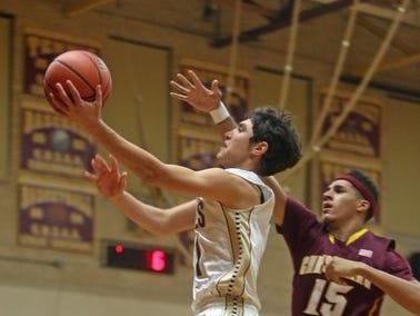 Iona Prep's Ty Jerome drives past Christ the King's Tyrone Cohen during a game at Iona Prep in New Rochelle. Jerome scored 37 points to lead the Gaels to the victory.