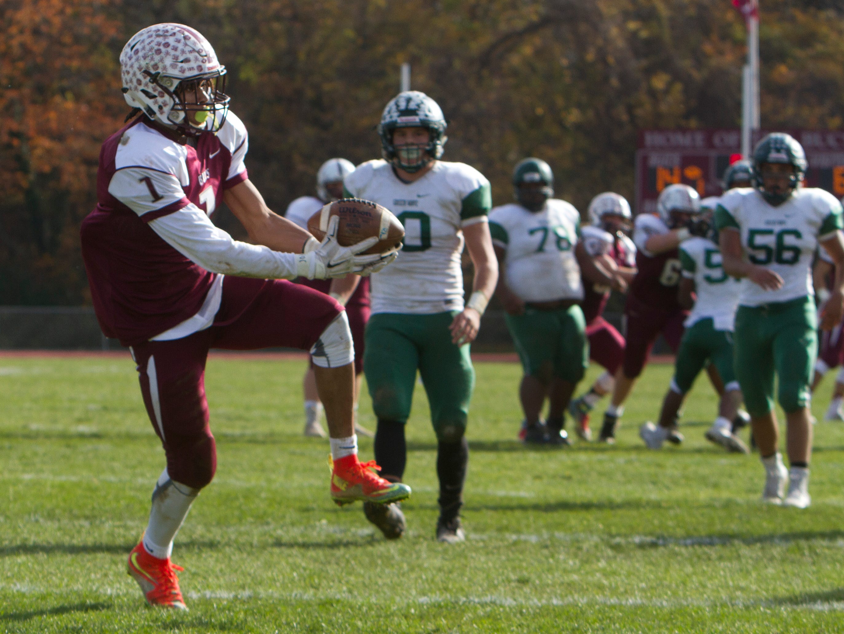 Red Bank Regional's Teddy Mitchell pulls down a pass over the middle and heads into endzone for his team's third touchdown of game. Long Branch vs Red Bank Regional Thanksgiving Day Football game in Red Bank NJ on November 26, 2015.