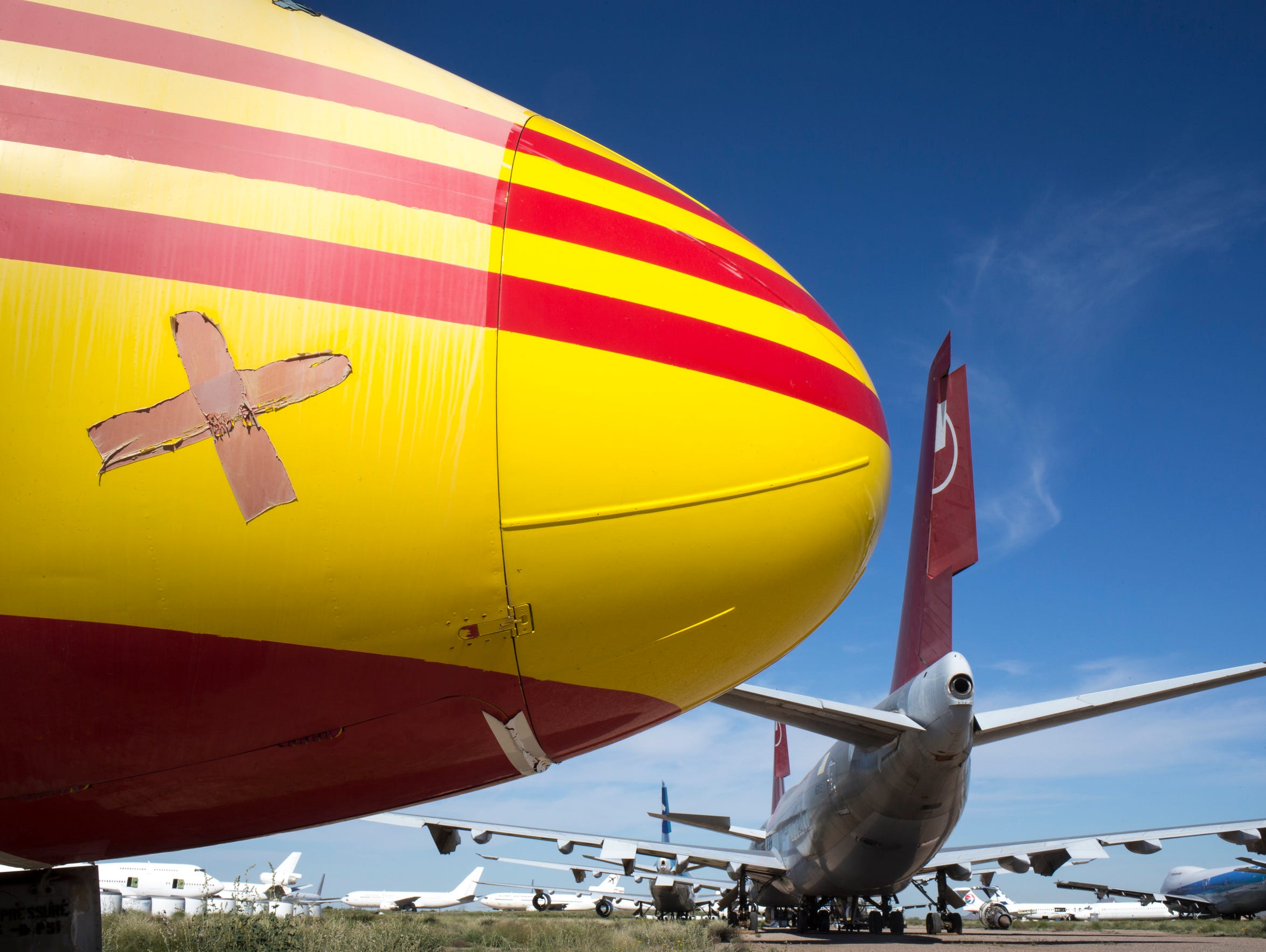 A DC-9 (yellow) sits at Pinal Airpark, Marana, Arizona.