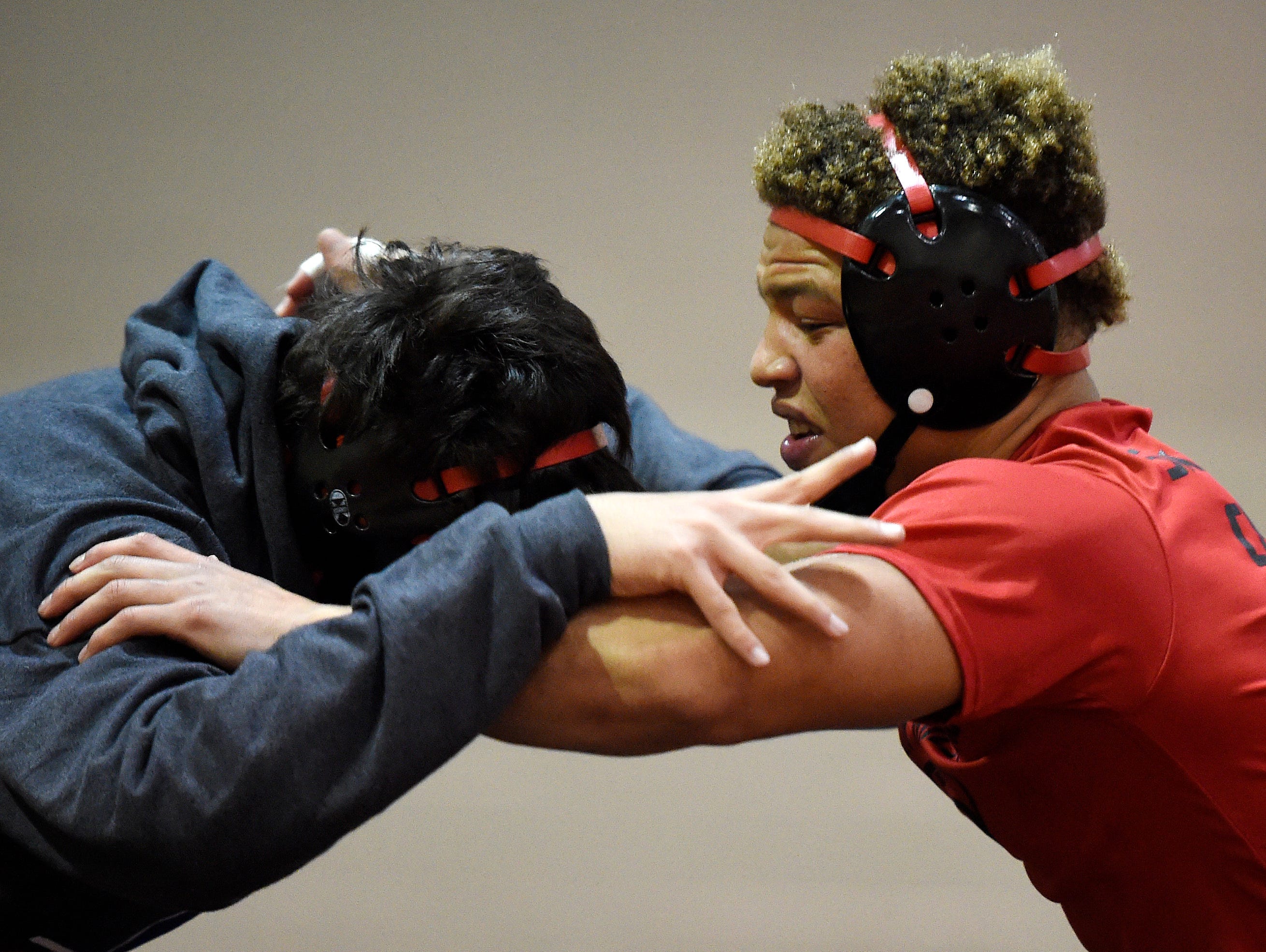 Ravenwood wrestler Chris Rowland, right, trains with teammate Rohan Nandwani, left, during practice at Ravenwood High School, Wednesday, Jan. 27, 2016, in Brentwood, Tenn.