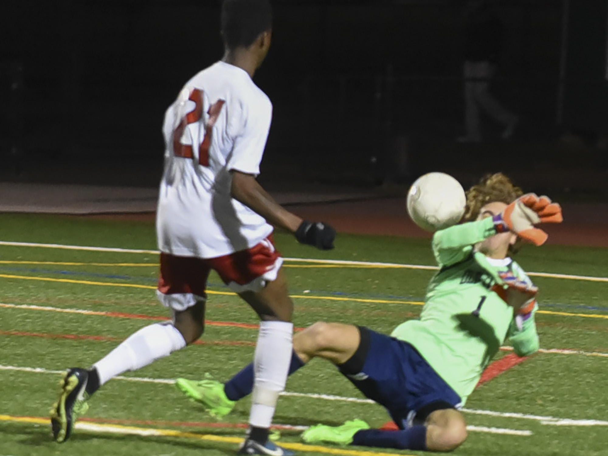 Mendham's Julian Montilus (21) beats Old Tappan goalie Jake Fiore (1) for the first score in the game in the NJSIAA Group III Semifinal at Ridge High School in Basking Ridge, November 17, 2015. Photo by Warren Wetura for the Daily Record.