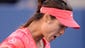 Li Na reacts after breaking the serve of Serena Williams.