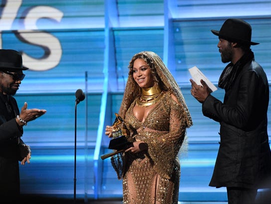 Beyonce accepts the Grammy for best urban contemporary
