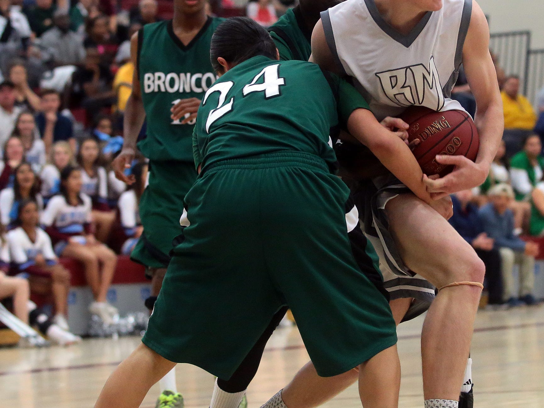Rancho Mirage High School sophomore William Webster (44, white) fights for possession of the ball during the second half of the Rattlers' home playoff game on Wednesday, February 18, 2015 against Banning.