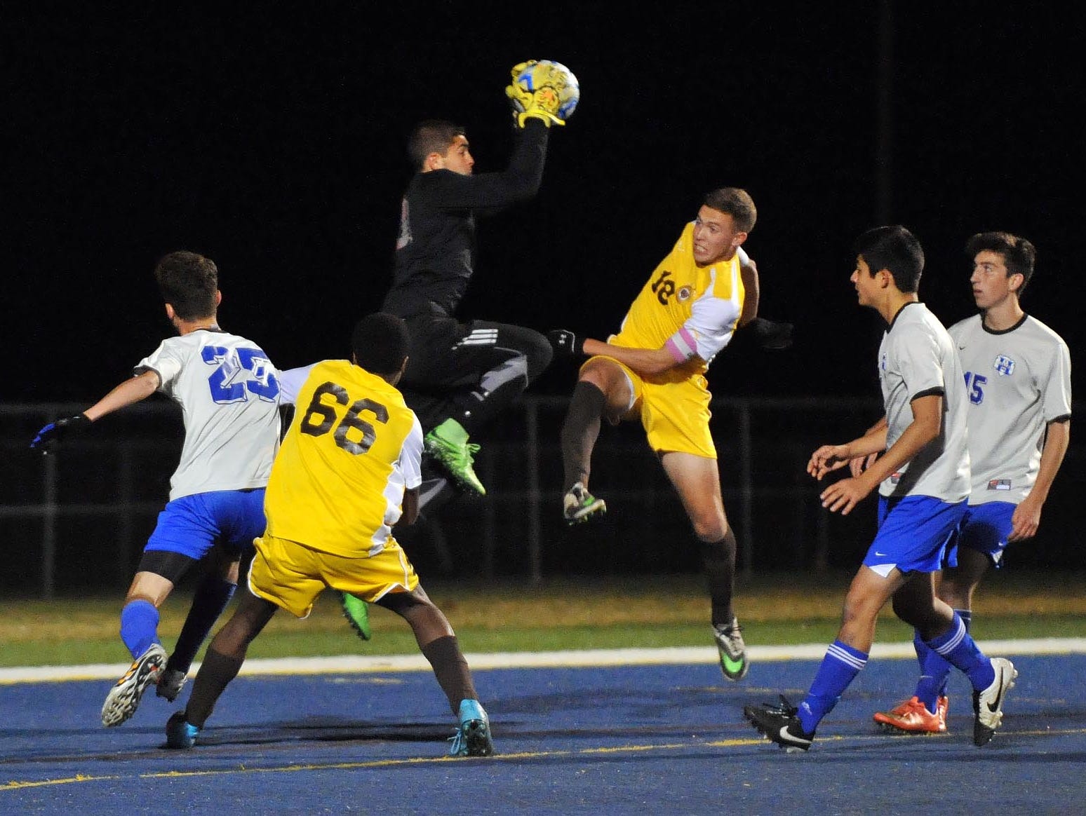 Holmdel goalkeeper Tyler Marchiano (top) makes a save against Delran in their Group 2 boys' soccer semifinal, Tuesday, Nov. 17 in Buena Vista.