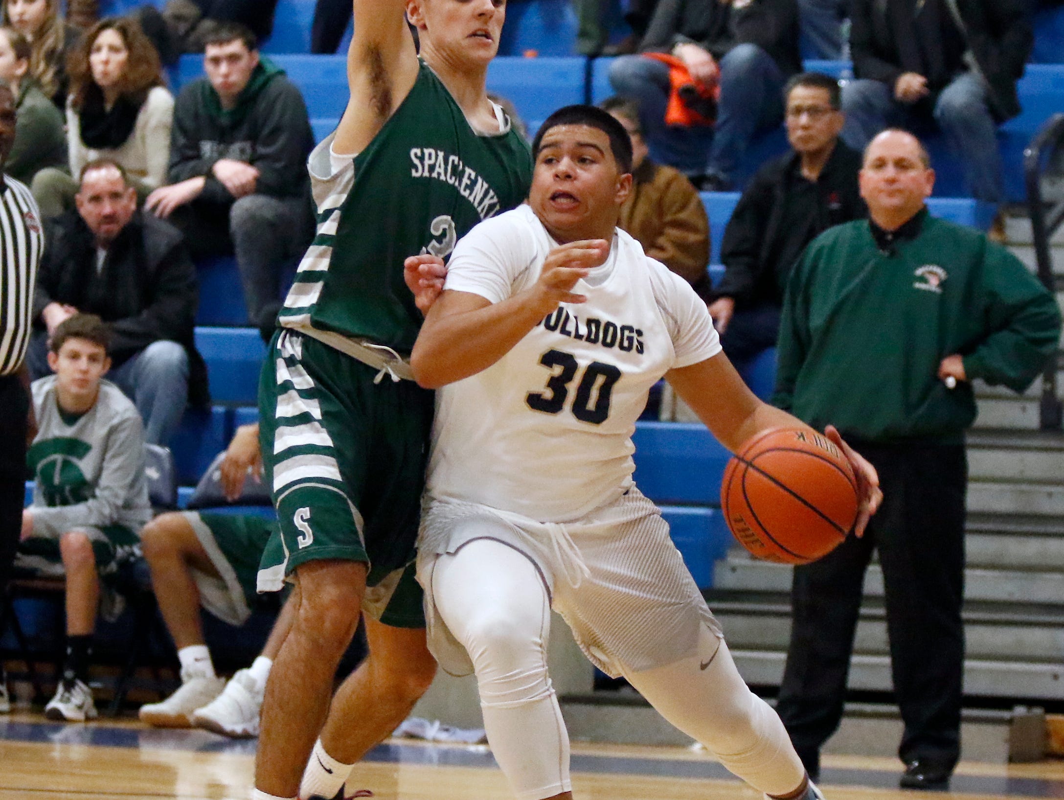 Beacon's Andre Davis (30) drives the baseline against Spackenkill's Haden Peek (3) in the championship game of the Duane Davis memorial basketball tournament at Our Lady of Lourdes High School in Poughkeepsie on Saturday, December 31, 2016.
