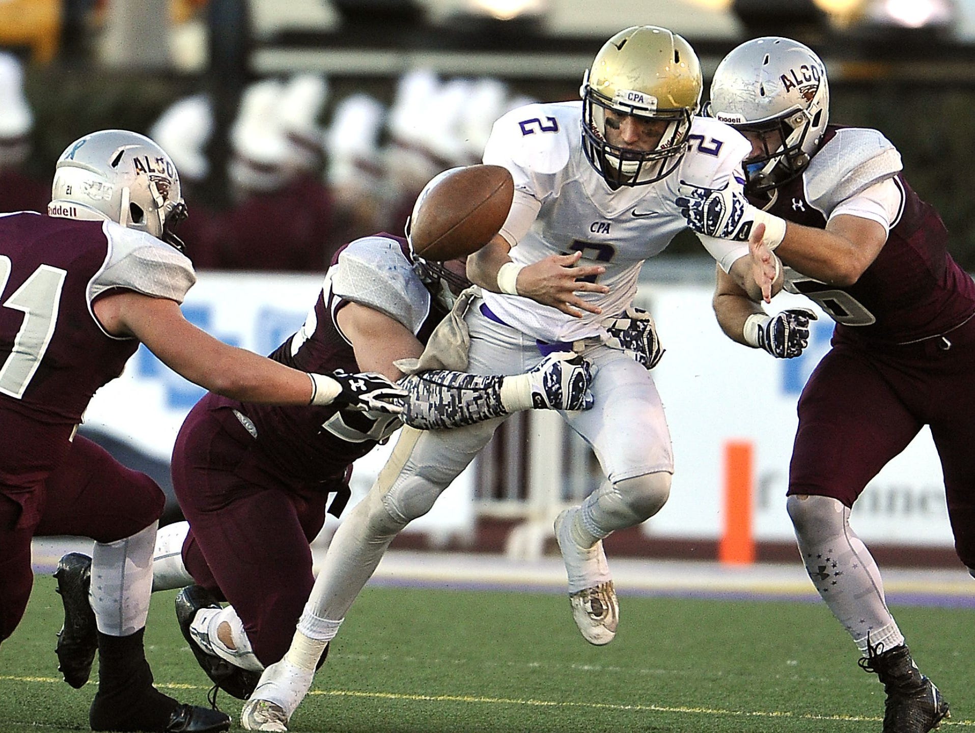 Pressured by Alcoa defenders, CPA quarterback Zack Weatherly loses the ball during Friday's 3A game. Alcoa beat CPA 20-0 in third straight title game meeting.