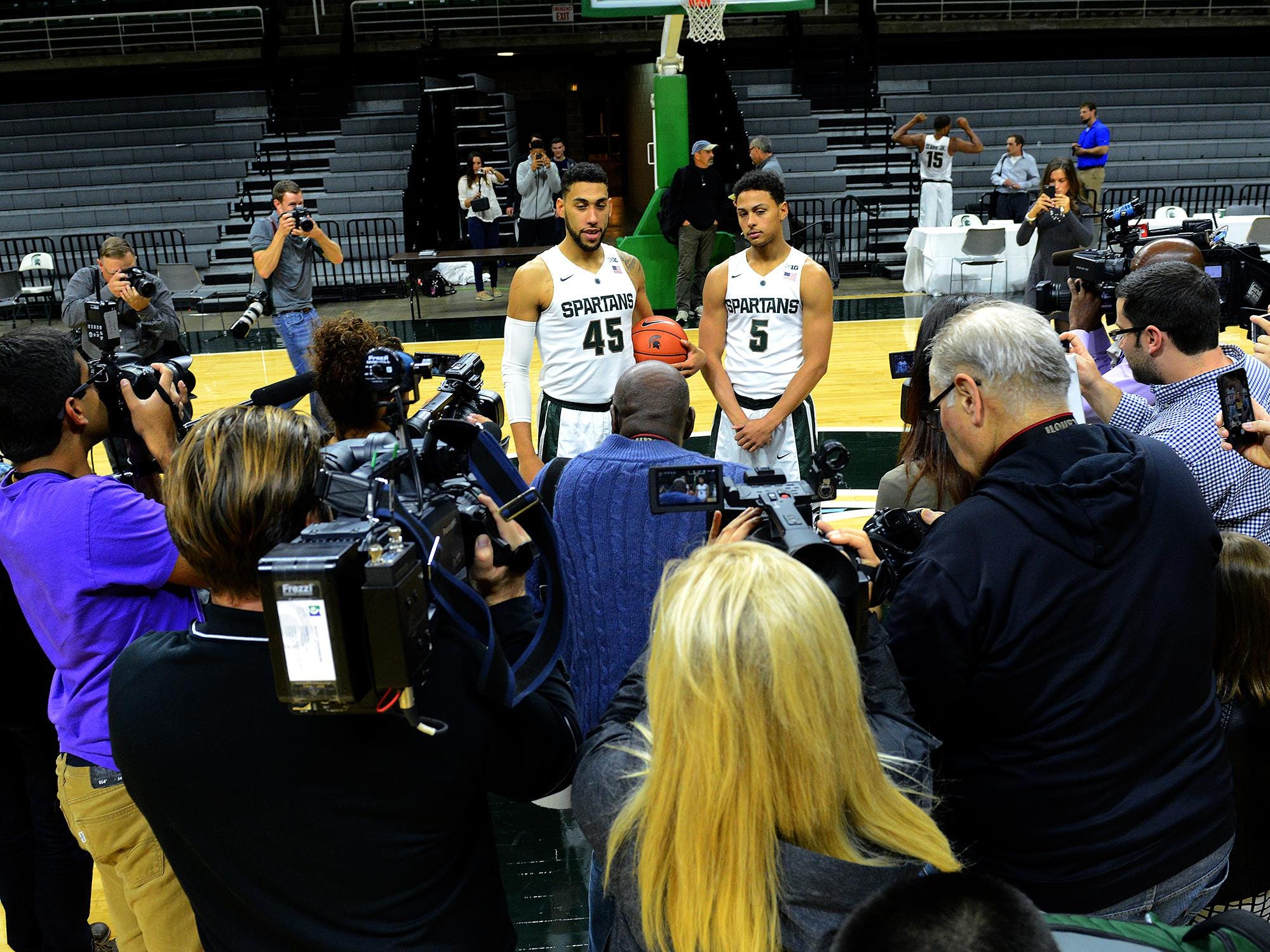 A throng of media members surround Denzel Valentine, right, and Bryn Forbes MSU men’s basketball media day on Oct. 27. All eyes are on the two Lansing Sexton products this season.
