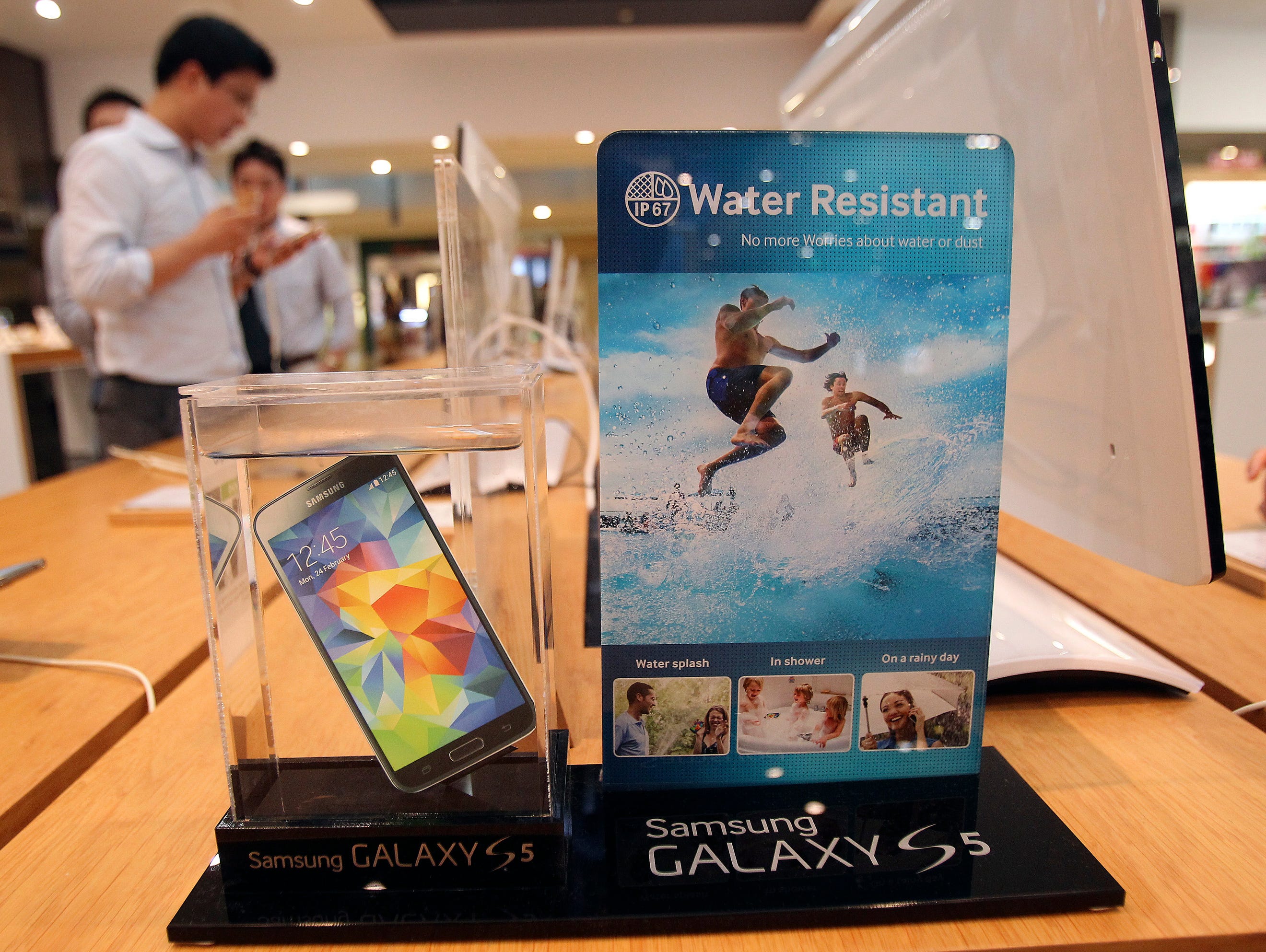 A Samsung Electronics' Galaxy S5 smartphone is displayed at the company's showroom in Seoul, South Korea. Samsung Electronics Co. reported a bigger-than-expected fall in second quarter profit on Thursday and said it was uncertain if earnings from its