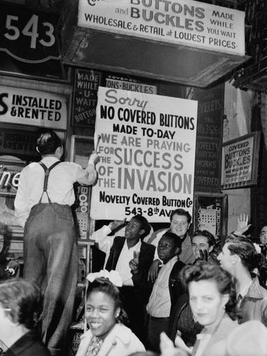 A New York haberdasher fixing up a sign explaining that his shop will be closed while staff pray for Allied victory in the invasion of Normandy on D-Day, 6th June 1944.