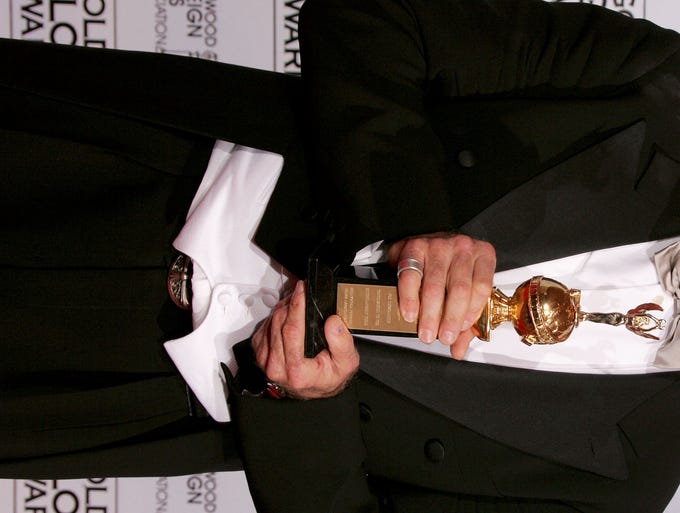 BEVERLY HILLS, CA - JANUARY 16: Actor Robin Williams poses with his award as recipient of the Cecil B. DeMille Award during the 62nd Annual Golden Globe Awards at the Beverly Hilton Hotel January 16, 2005 in Beverly Hills, California.