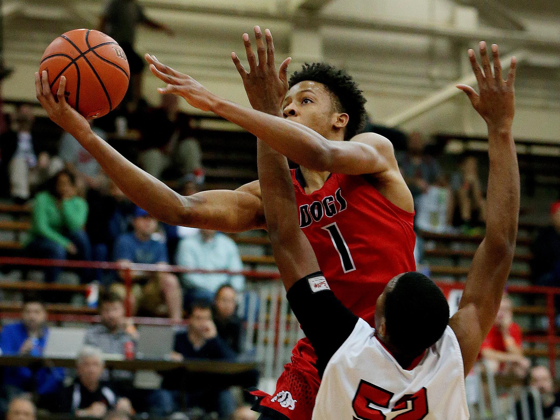 New Albany’s Romeo Langford (1) goes up for the shot and is fouled by Pike’s Durante Lee (52) during the Tip Off Classic on Dec. 12, 2015.