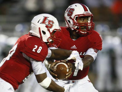 La Salle QB Nick Watson hands the ball off to RB Jeremy Larkin.