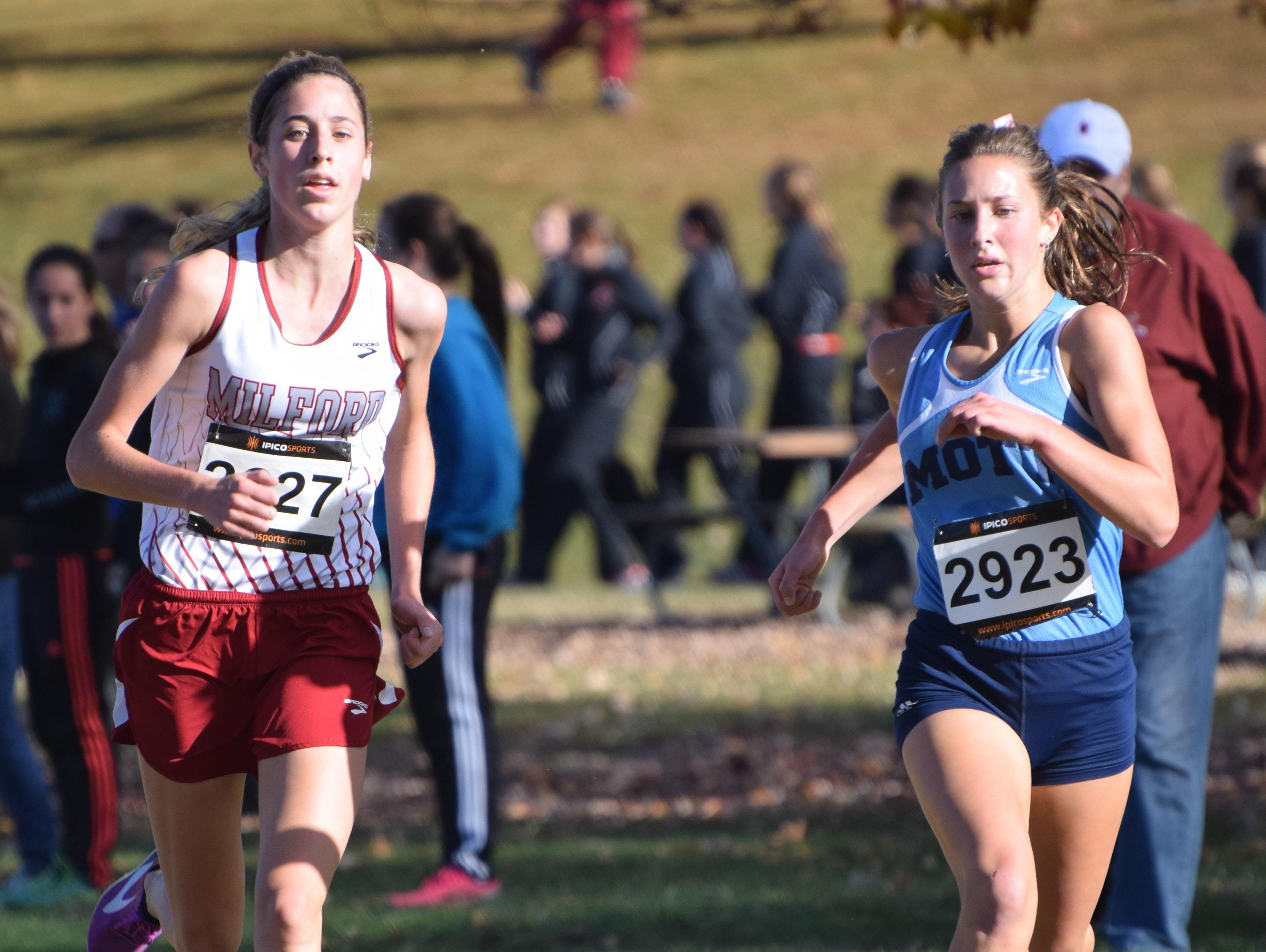 Milford’s Mallory Barrett (left) nipped Waterford Mott’s Katie Osika at the finish line for first place.