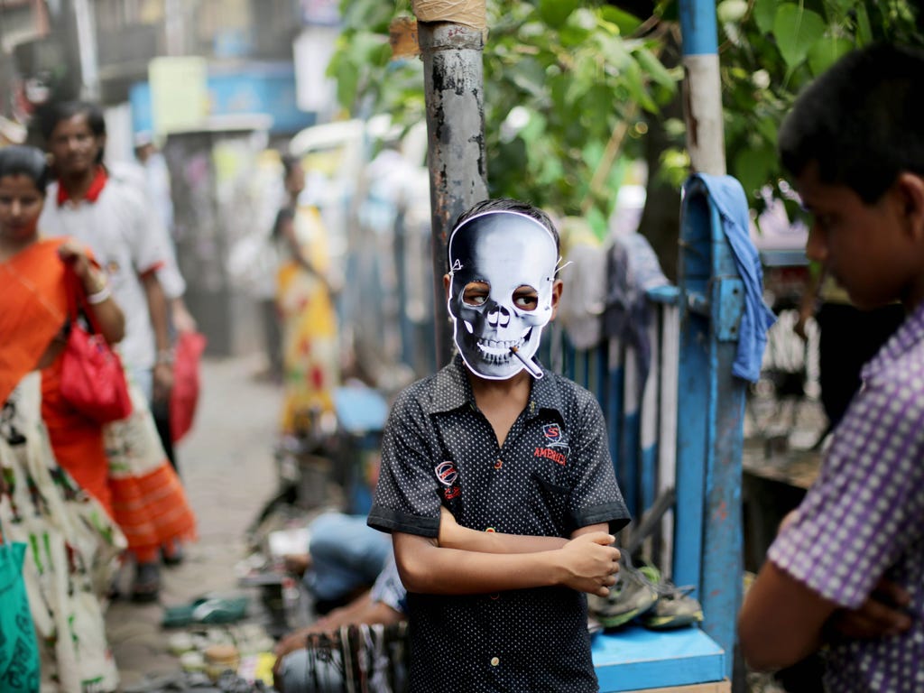 A young activist wears a mask resembling a human skull as he takes part in an anti-smoking campaign rally on World No Tobacco Day in Calcutta, India.