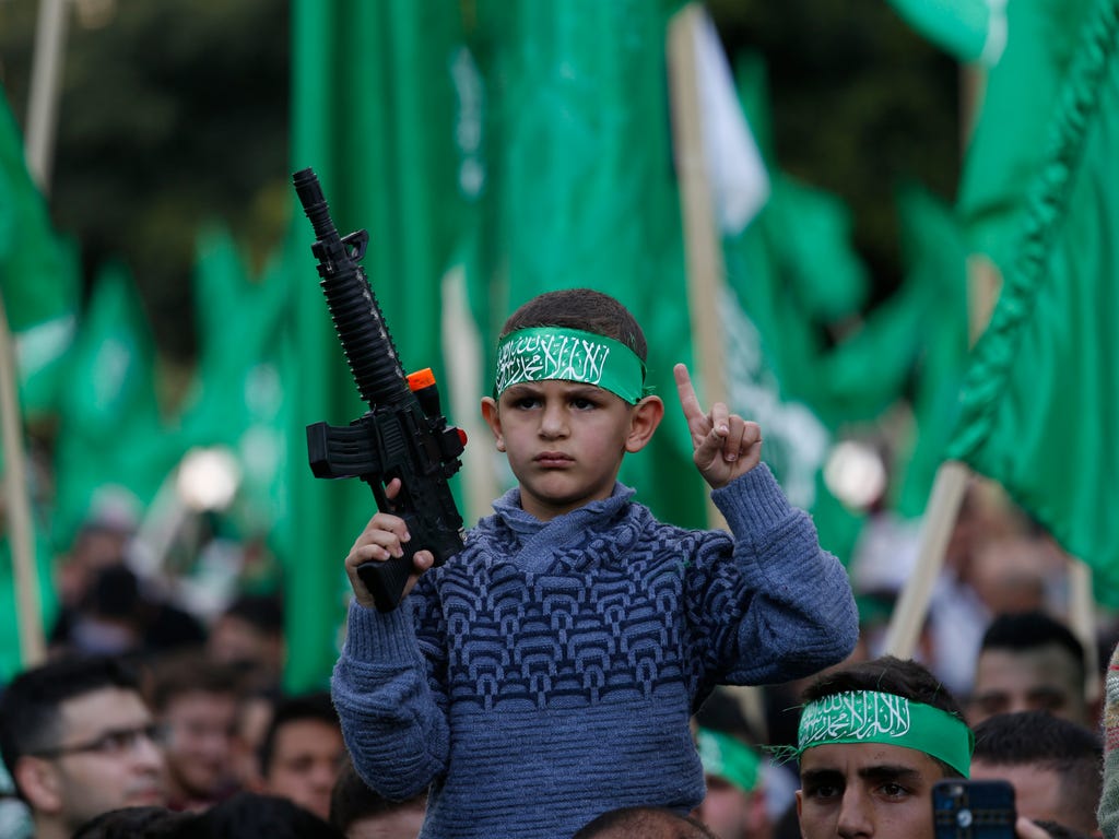 Palestinian Hamas supporters attend a rally marking the 30th anniversary of the Hamas movement in the West Bank City of Nablus.
