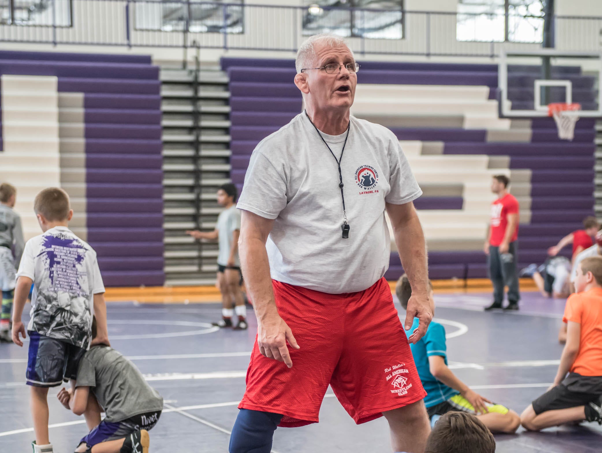 Rob Waller works with kids at Rob Waller's All-American Wrestling Camp at Lakeview High School on Wednesday.