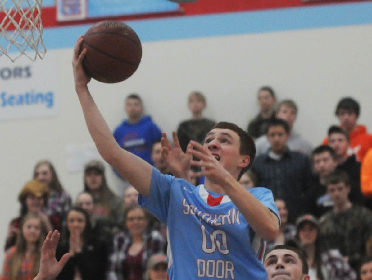 Southern Door's Trevor Hawkey drives past Wrightstown's Jacob Gilson during a Division 3 regional semifinal game in March. Hawkey averaged 11.9 points and a team-best 7.3 rebounds per game last season.