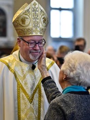 Bishop Christopher Coyne is congratulated by his mother,