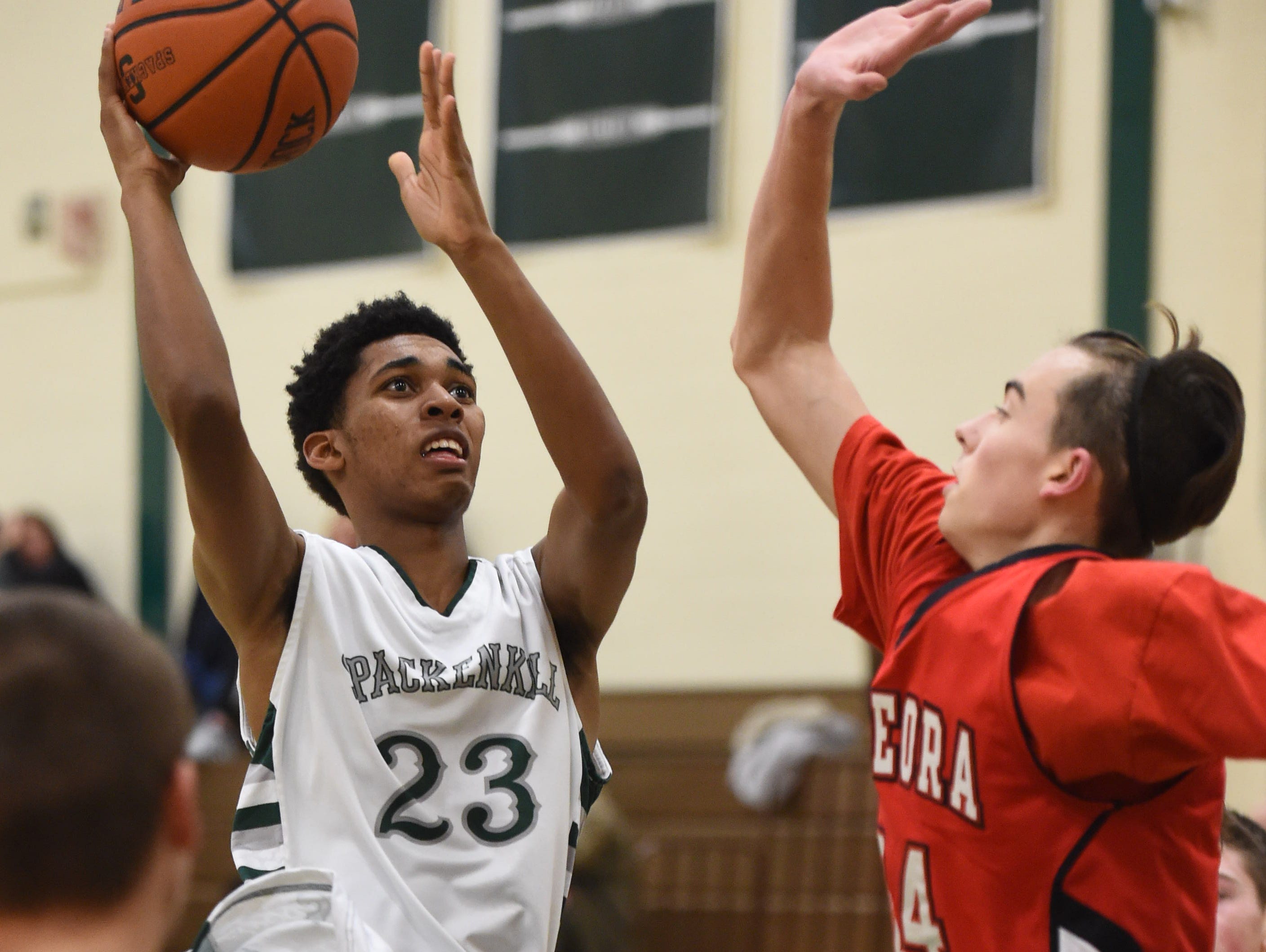 Spackenkill's Stanley Garrant takes a shot as Onteora's Miles Eberhard covers him during Thursday's game at Spackenkill.