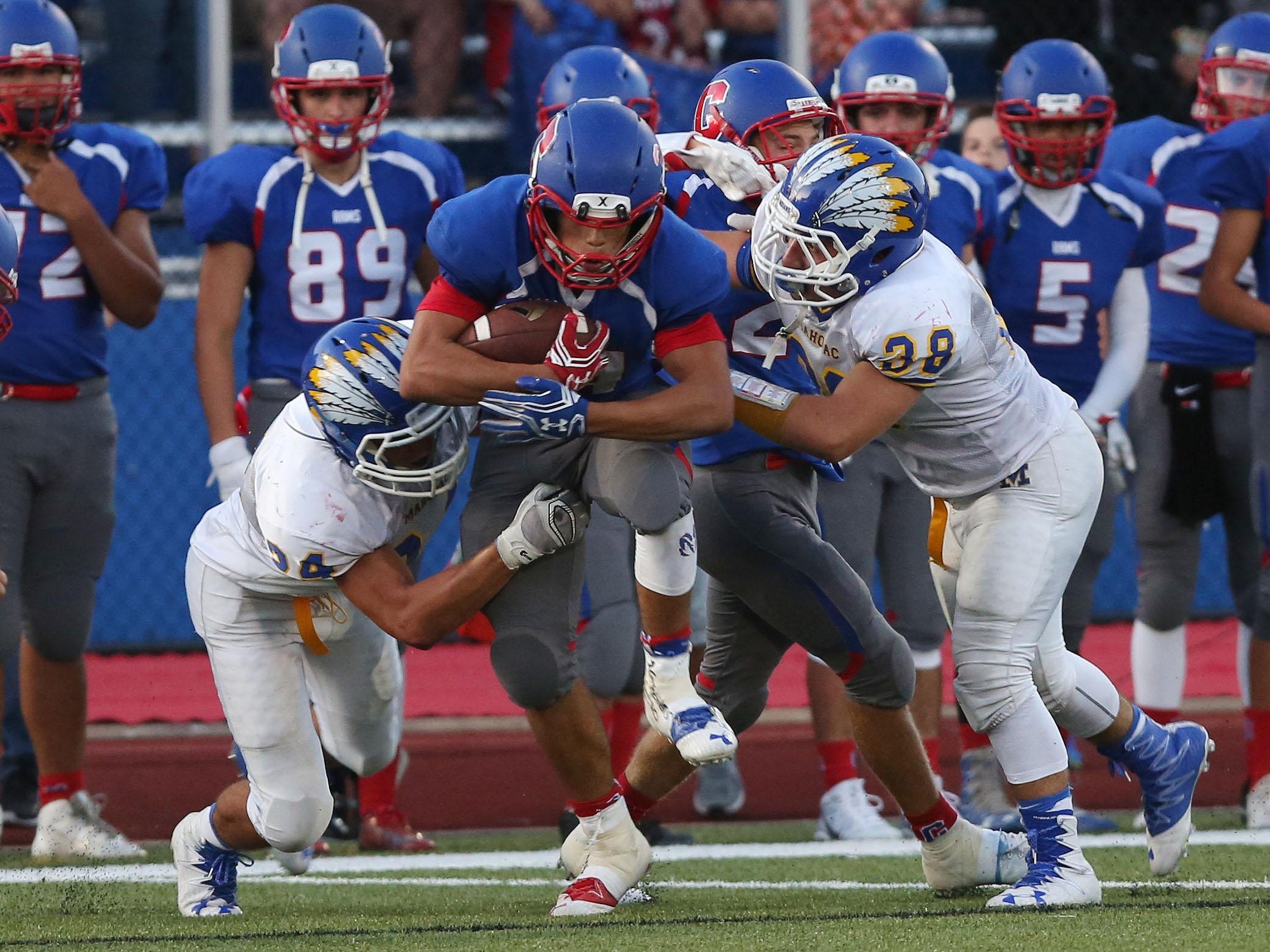 Carmel's David Vega tries to break away from Mahopac’s Robert Hoyt, left, on a first-half run during Friday’s game at Carmel High School.