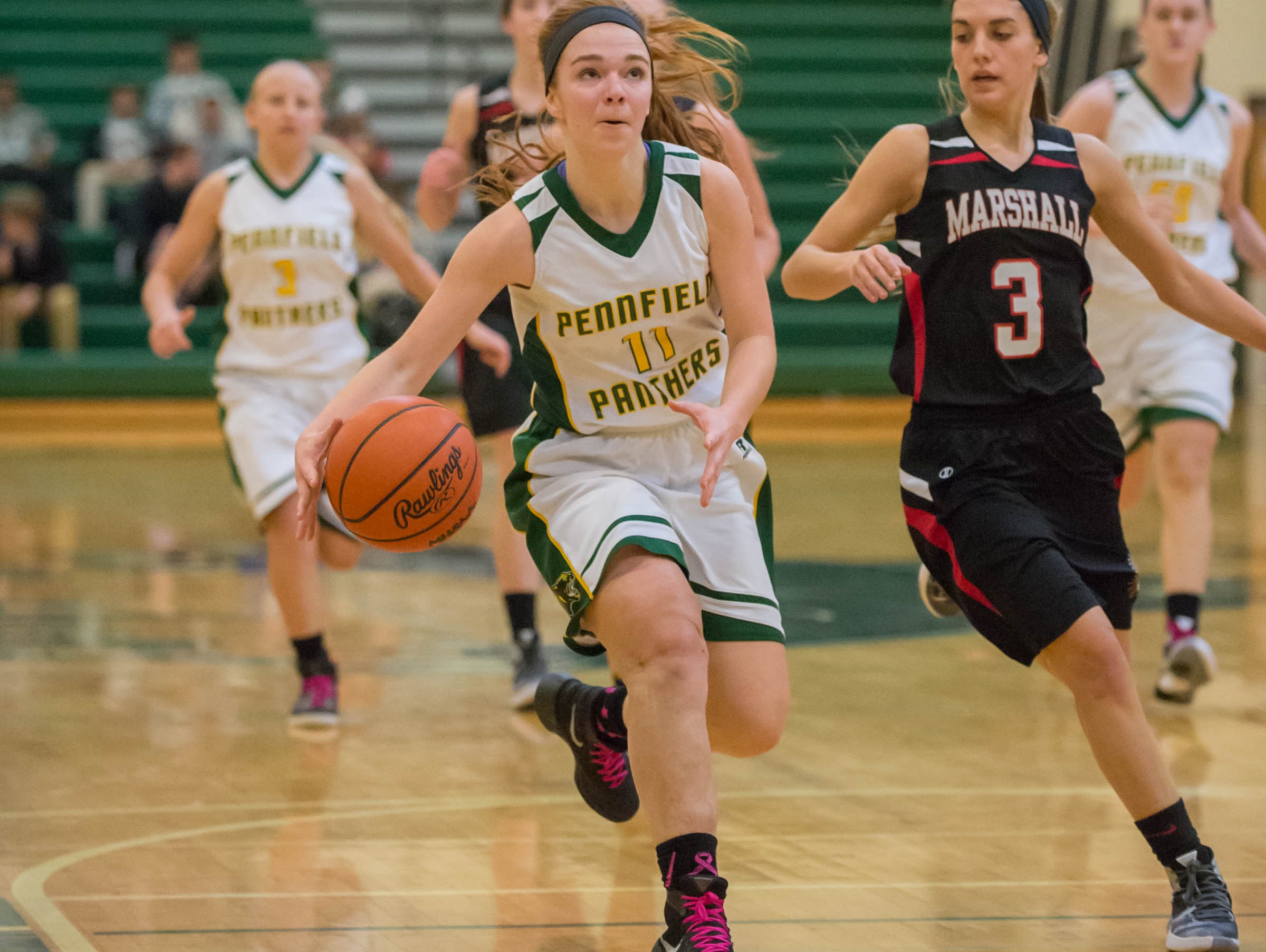 Pennfields's Melsnie Mcintyre (11) bring the ball down the court against Marshall Friday evening.