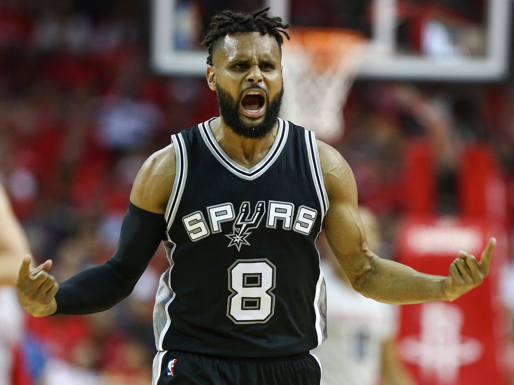 San Antonio Spurs guard Patty Mills celebrates after a play during the second quarter against the Houston Rockets in game six of the second round of the 2017 NBA Playoffs at Toyota Center ini Houston.