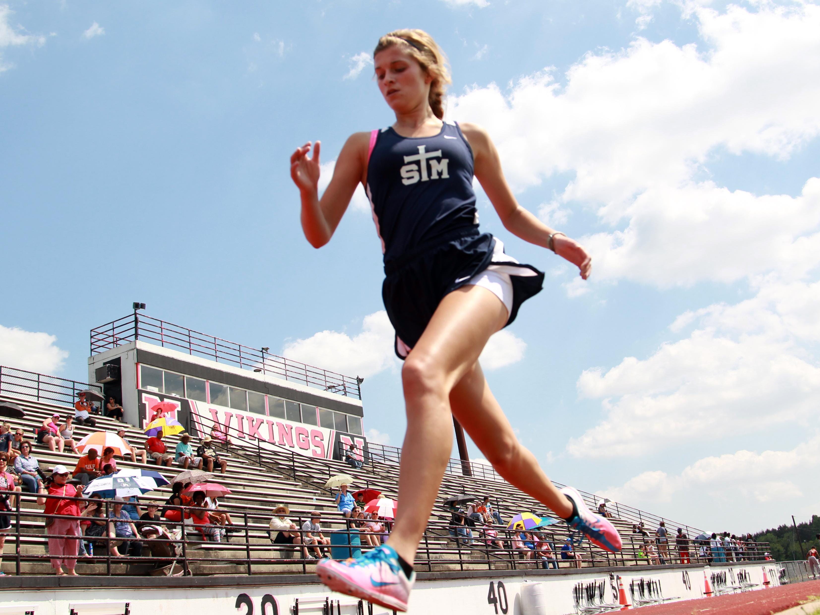 St. Thomas More's Hannah Bourque finishes first in the girls 1600 meter race during a high school track meet at Northside High Wednesday, April 23, 2014 in Lafayette, La.