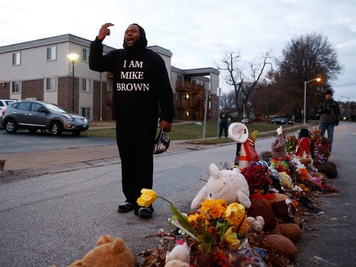 A protester in a sweatshirt that reads 'I Am Mike Brown'