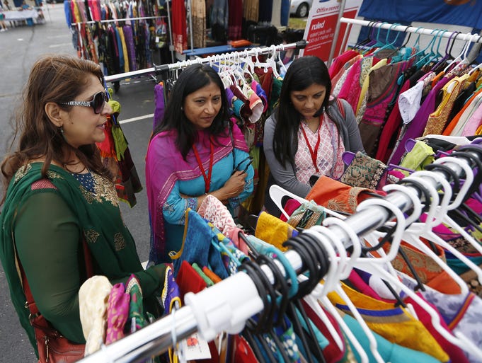 Sankhya Jejurikar, left Sangeeta Desai and Kashmira Bapat, all of Sycamore Township, shop at the open market during the Taste of India at the Hindu Temple of Greater Cincinnati.