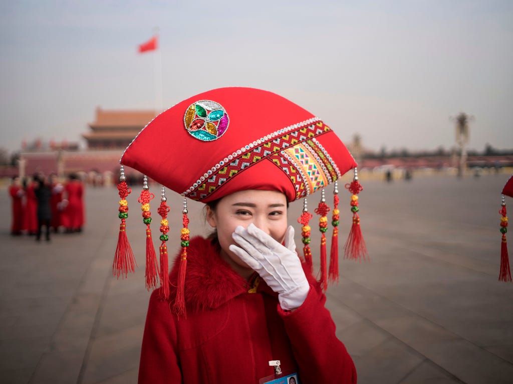 A Chinese hostess reacts at Tiananmen square during the opening session of the National People's Congress, China's legislature, in Beijing on March 5, 2018.\u000dChina's rubber-stamp parliament opens a major annual session set to expand President Xi 