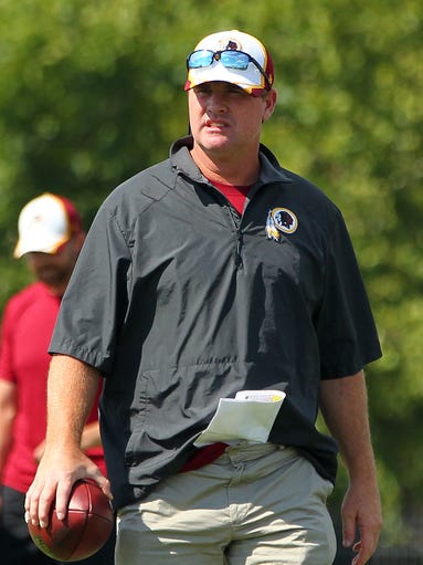 Jul 24, 2014; Richmond, VA, USA; Washington Redskins head coach Jay Gruden walks on the field during an afternoon walkthrough on day two of training camp at Bon Secours Washington Redskins Training Center. Mandatory Credit: Geoff Burke-USA TODAY Sports
