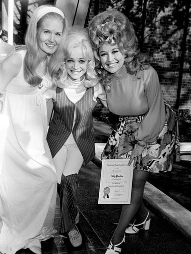 Three of the nation's most prominent female country singers — Lynn Anderson, left, Barbara Mandrell and Dolly Parton — appear proud to see their names in the Walkway of Stars on May 5, 1972, at the Country Music Hall of Fame. Their names, along with those of Gene Autry, the Statler Brothers, Glenn Sutton, Bonnie Owens and Charley Pride, were placed in the walkway.