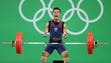 Sinphet Kruaithong (THA) competes during the 56kg weightlifting
