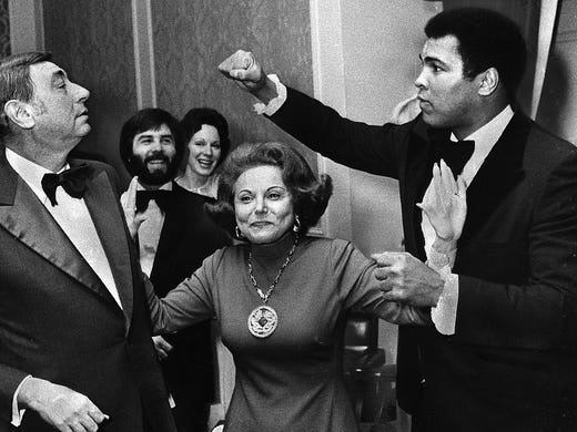 At a dinner honoring the six "Outstanding Chicagoans of Today," boxing champ Muhammad Ali takes a playful poke at sportscaster Howard Cosell, as Ann Landers advises them to break it up on Nov. 11, 1977.