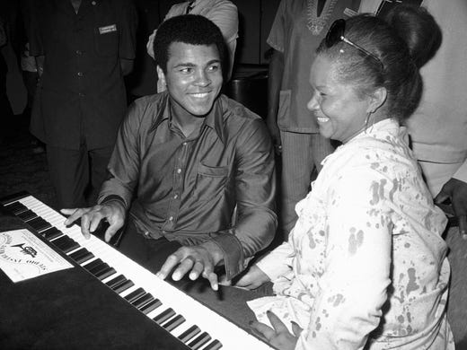 Muhammad Ali plays a few notes on the piano while visiting black American artists that perform in the Zaire 74 music festival in Kinshasa, Zaire, Sept. 22, 1974. At right is singer Etta James.
