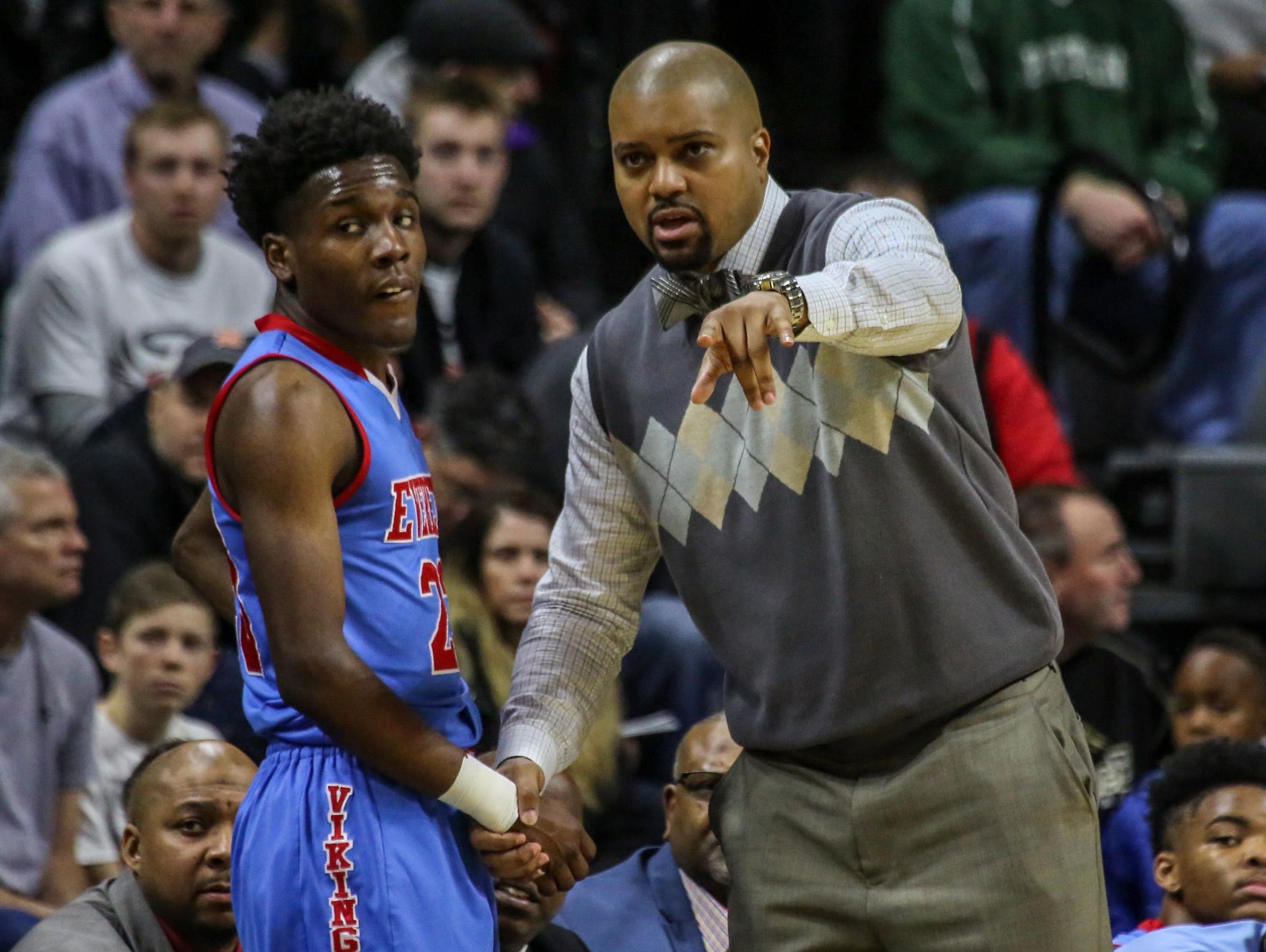 Lansing Everett's head coach Desmond Ferguson talks with Victor Edwards, during the MHSAA boys basketball Class A semifinals against North Farmington at the Breslin Center in East Lansing, Mich. on Friday, March 25, 2016.