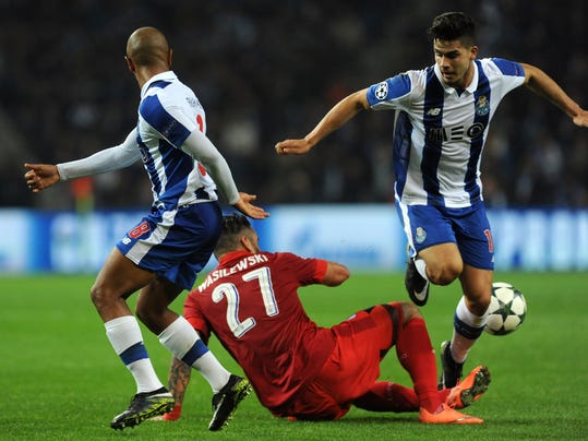 Leicester's Marcin Wasilewski, on the ground fights for the ball with Porto's Yacine Brahimi, left, and Andre Silva during a Champions League group G soccer match between FC Porto and Leicester City at the Dragao stadium in Porto, Portugal, Wednesday, Dec. 7, 2016. (AP Photo/Paulo Duarte)