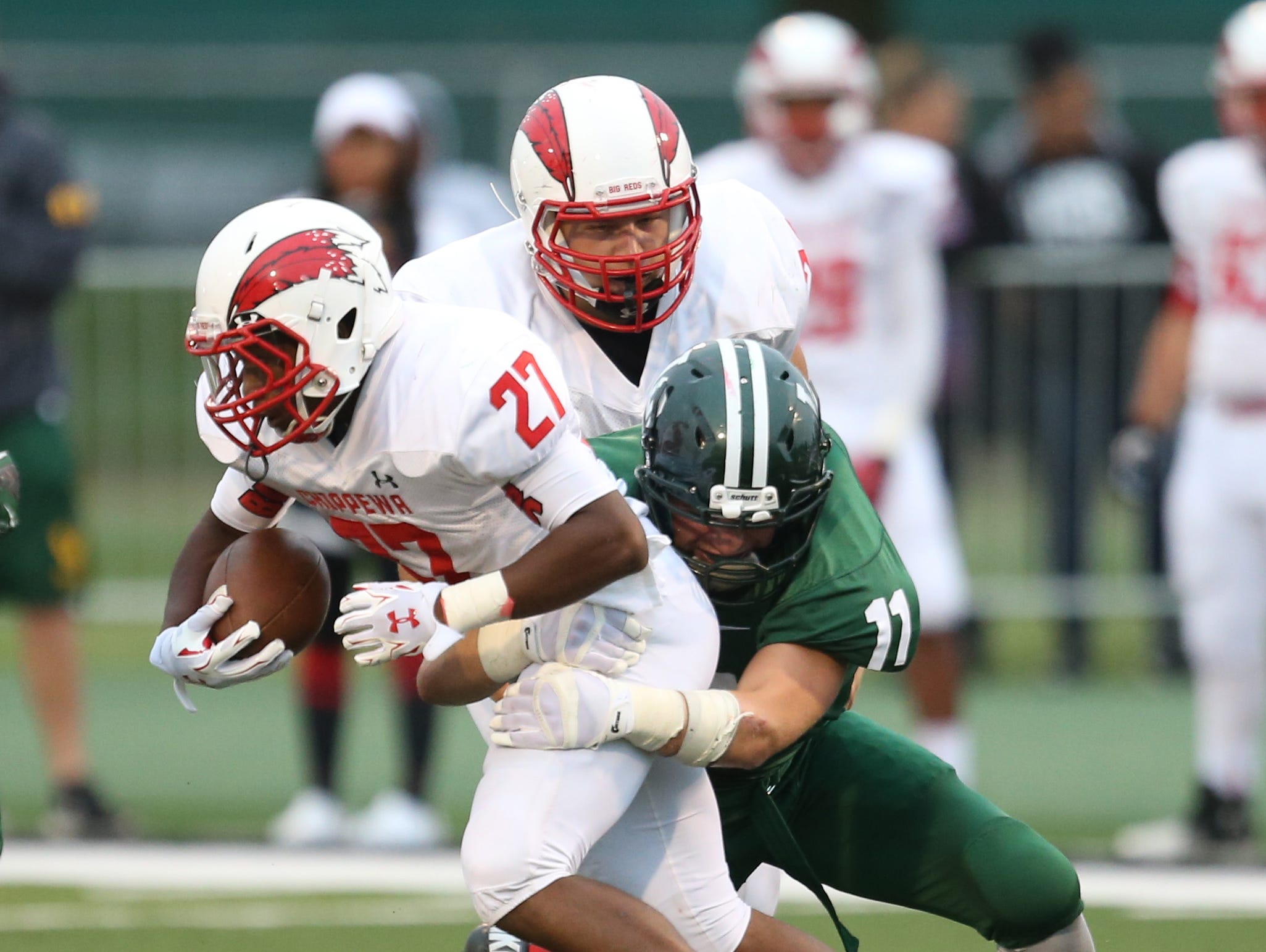 Chippewa Valley high schools Daren Greeley is tackled by Lake Orion high schools Jack McClear during first half action of the Prep Kickoff Classic on Thursday, August 27, 2015 at Wayne States Tom Adams Field in Detroit Michigan.