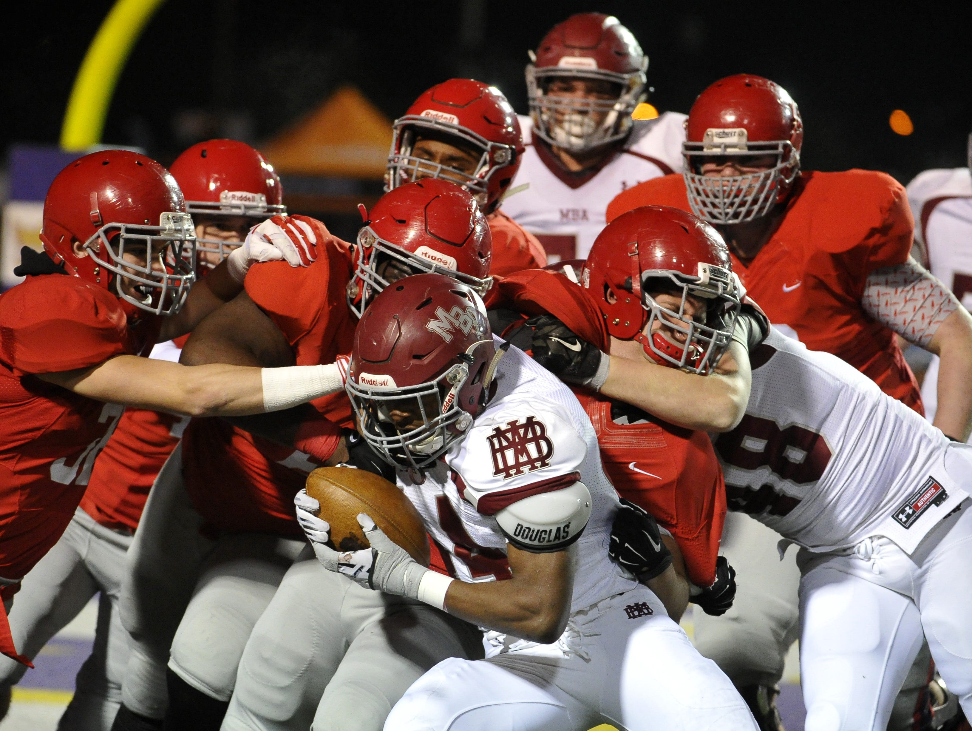 MBA's Ty Chandler drags a horde of Brentwood Academy tacklers with him during the DII-AA state title game.
