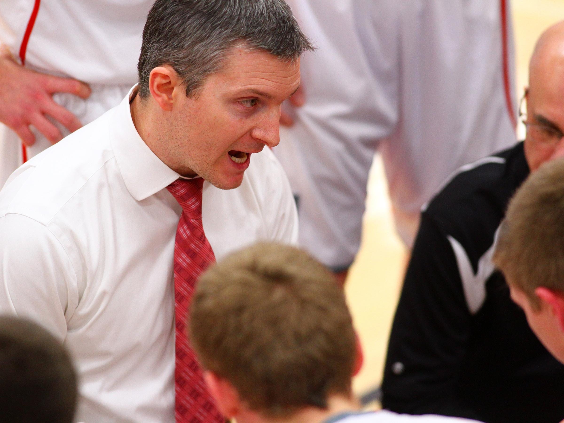 Utica coach Brian Radabaugh talks to his team during a 2014-15 game.