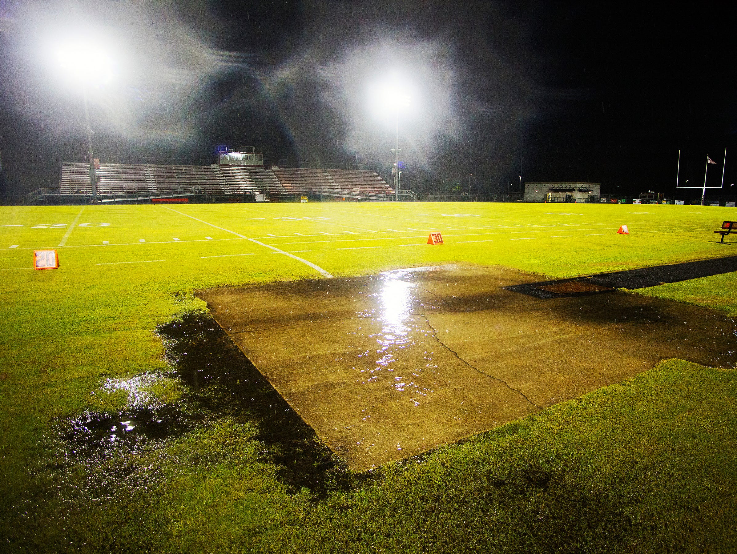 Water pools on the football field at South Fort Myers High School last Friday. South's game against Island Coast was one of many area football games cancelled due to rain and lightning.