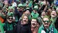 People cheer as they attend the St. Patrick's Day parade.