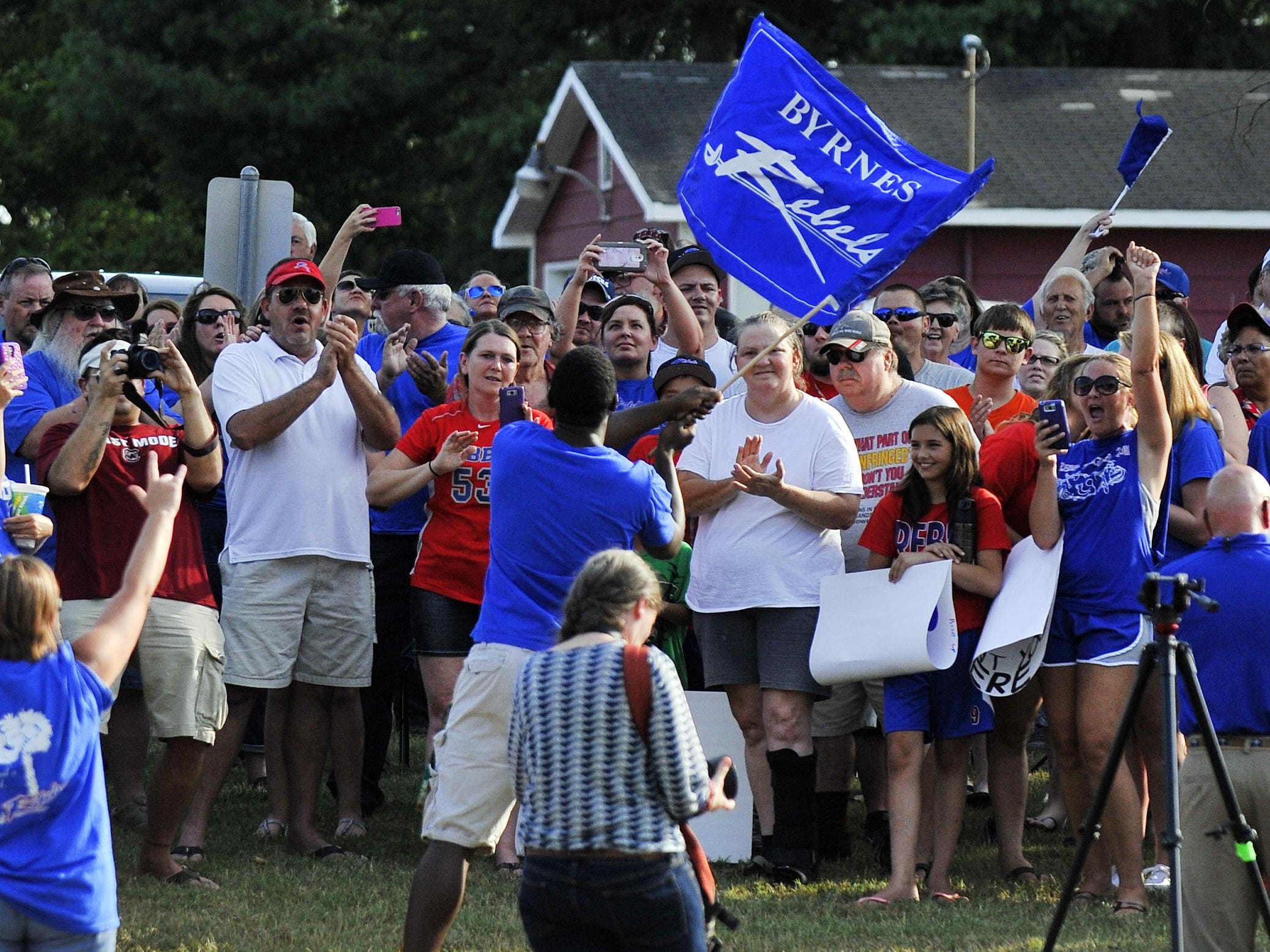 A large group of supporters of the Byrnes High School “Rebels” nickname gathered across from the school to rally on Monday, July 20, 2015.