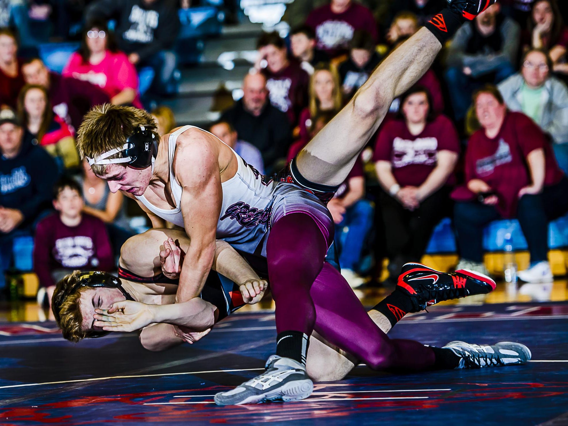 Hunter George,top, of Eaton Rapids throws Braxton Parks of St. Johns to the mat during their 145lb. match in their Division 2 Regional final Wednesday February 17, 2016 in Mason. George would complete the the pin seconds later.