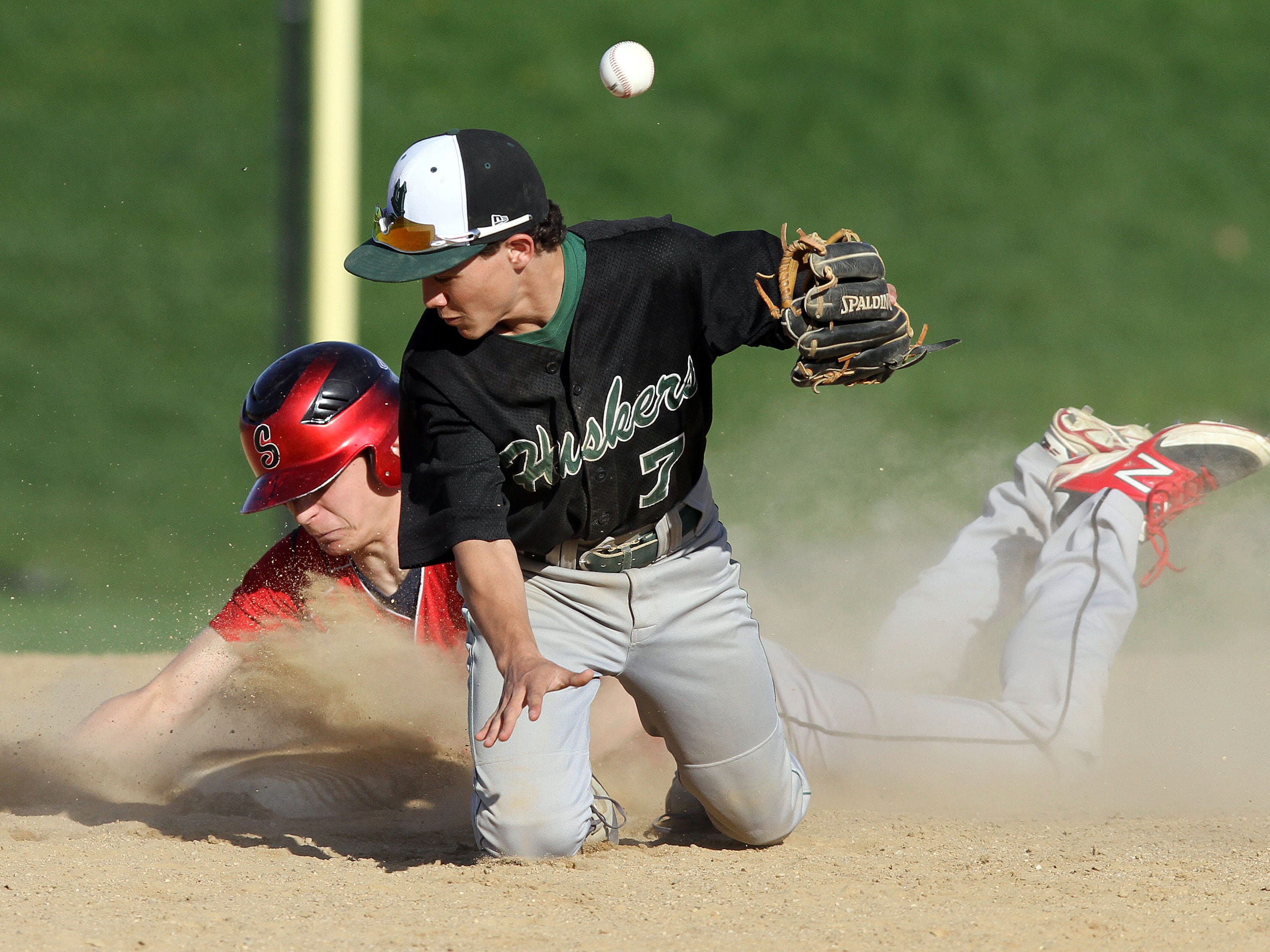 Yorktown's Jake Bichler (7) can't handle the throw as Somers Mike Acocella (10) slides safe into second with a stolen base during a baseball game at Somers High School April 29, 2015. Somers won the game 7-5.