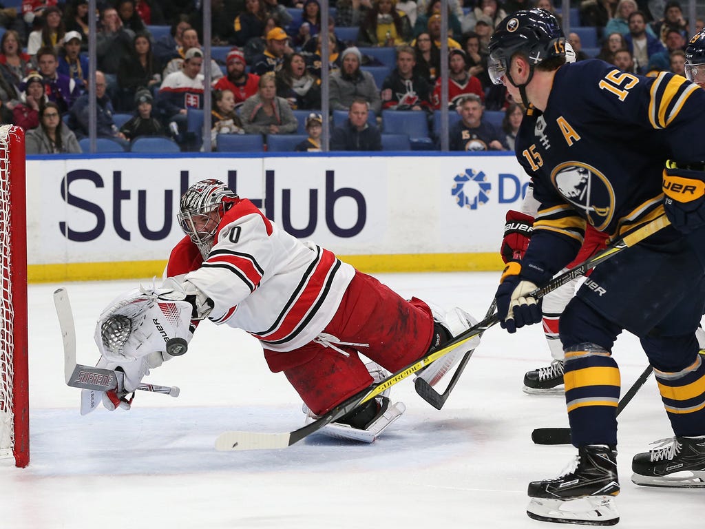 Sabres center Jack Eichel (15) scores past diving Hurricanes goalie Cam Ward (30) during the second period in Buffalo. Eichel notched his first career hat trick, but it wasn't enough as the Hurricanes won 5-4 in overtime.