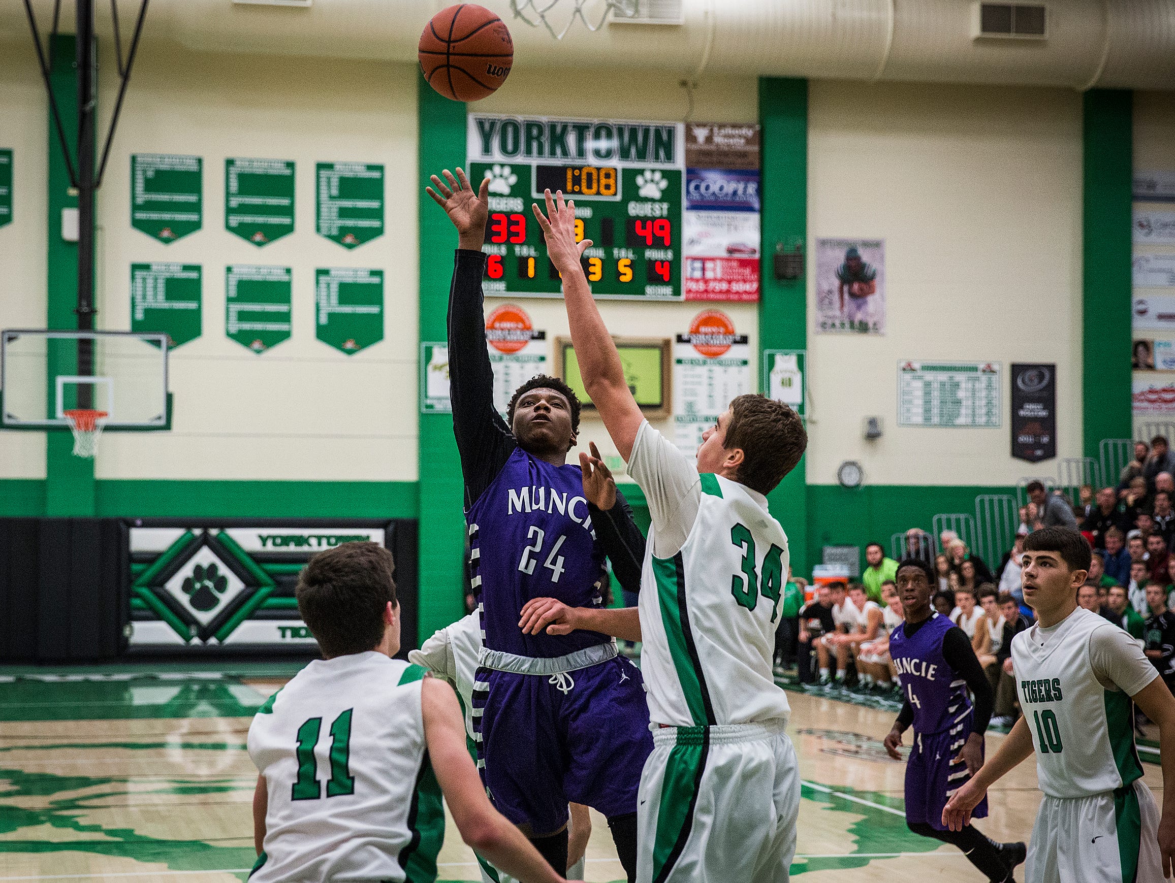 Central's Phillip Corthen shoots past Yorktown during their game at Yorktown High School Saturday, Nov. 28, 2015.