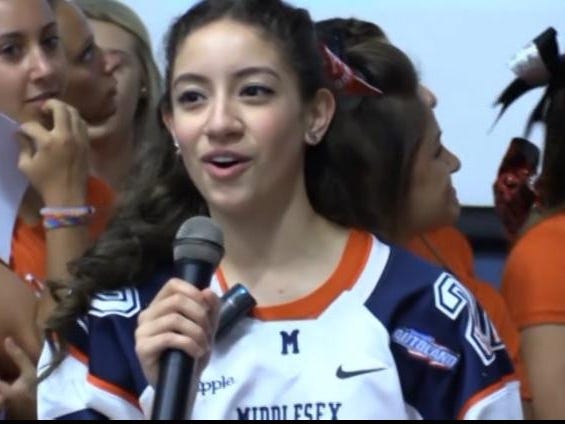 Amanda Leon of Perth Amboy sings parody of Taylor Swift’s “22” during Middlesex County Snapple Bowl All-Star football team’s pep rally at the Lakeview School in Edison on Monday